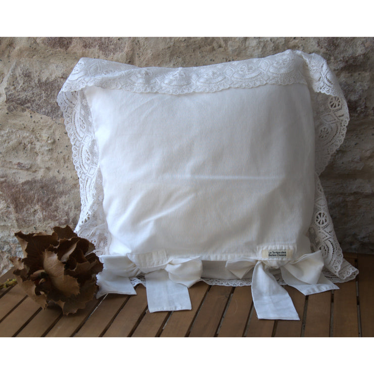 Old cotton decorative cushion, knots on the back, frilly embroidery.