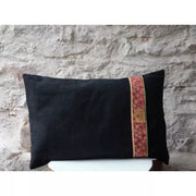 Black linen decorative cushion and velvet trimmings bands.