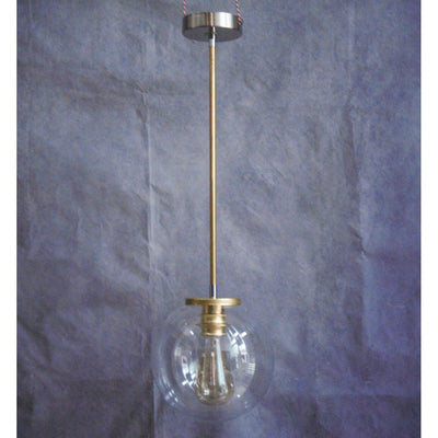 Minimalist brass tube suspension and transparent glass globe.