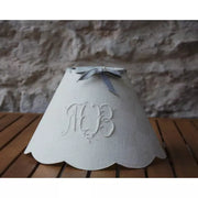 White scalloped flame clip cone shade with monogram.