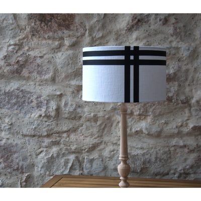 Round linen lampshade, black border.
